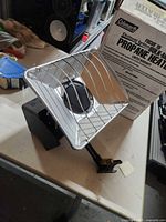 Coleman Focus 15 heater unit on table showing reflector, grille, housing and mounting arm