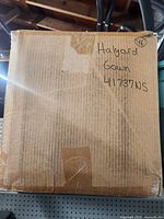 Front of sealed box showing handwritten label Halyard Gown 41737NS