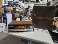 Receiver and two speakers on table, overall view