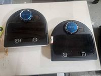 Both Neato Botvac vacuums side by side showing overall condition and missing chargers