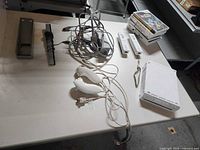 Overall view of console, remotes, nunchuks, sensor bar, cables and game stack