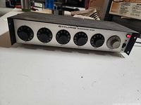 Front view showing Shure branding, five channel knobs, master knob, power LED