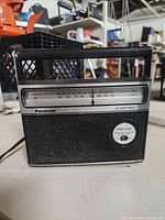 Front view showing tuning scale, speaker grille, controls