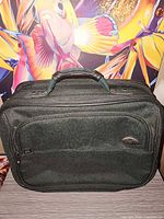 Fabric laptop briefcase with front zip pocket and oval logo