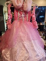 Front view of pink layered princess costume dress with collar