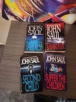 Front covers of the four John Saul paperbacks displayed on tabletop