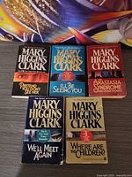 Front covers of all five Mary Higgins Clark paperback novels