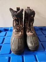 front view of both boots showing rubber shell and lacing