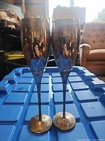 Front view showing two silver-plated flutes with tarnished bases