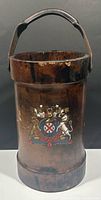 Full view of leather fire bucket showing crest and handle