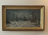Full view of framed winter landscape painting on wall