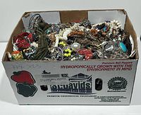 Full view of produce box filled with tangled jewellery