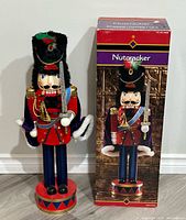 Nutcracker front view beside original box