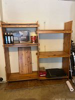 Front view of the solid wood shelving unit showing adjustable shelves and overall construction