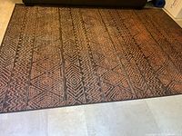 Full view of area rug showing entire geometric pattern and colours