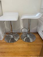 Both stools side by side showing seats, posts, bases