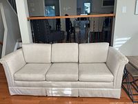 Front view showing entire sofa, cushions, upholstery, skirt