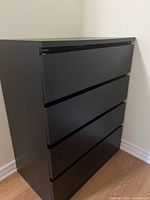 Black four-drawer dresser angled view