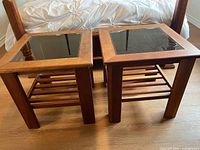 Both matching cherry wood end tables side by side, showing glass tops and slatted shelves
