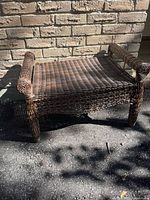 wicker bench without cushion showing weave and structure