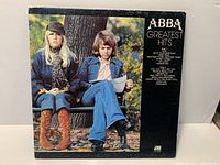 Front album cover showing title, artist and visible wear