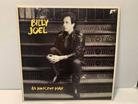 Front cover showing album artwork, artist name, album title, visible small tear at top right corner