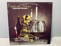 Front cover of Doug and the Slugs "Cognac and Bologna" LP showing artwork and handwriting