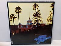 Front cover of Hotel California jacket showing palm trees and hotel building