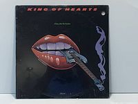 Front cover of sealed LP showing artwork, drill hole, shrink wrap