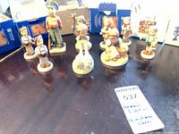 All ten Goebel Hummel figurines with boxes on table