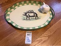 Tray and piggy bank together on floor with lot tag
