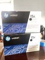 Front view of both sealed HP LaserJet 15A and 15X toner cartridge boxes