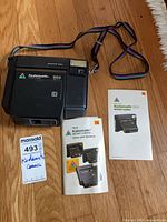 Front view of Kodak Kodamatic 960 camera with manuals