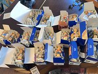 Overview of open blue boxes containing multiple Hummel figurines