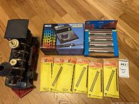 Group shot of locomotive body, power pack box, Car Pak passenger cars, six Atlas track packages