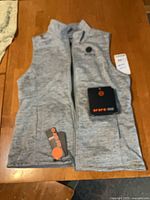 Front view of vest with battery pack and tags visible