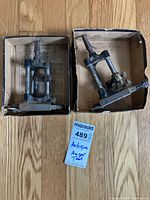 Two hollow augers each in a cardboard box