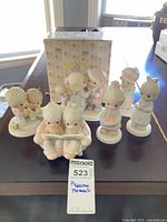 Group shot of all seven figurines with box visible