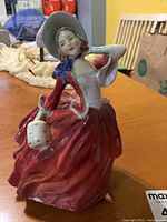 Front view of Royal Doulton Autumn Breezes figurine showing colors, pose, and overall condition