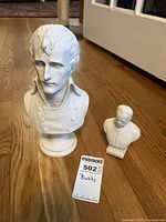Front view of both busts showing relative sizes and finishes
