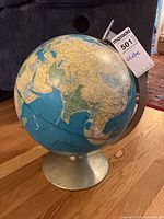 Full view of globe showing Europe, Africa, Asia and metal stand