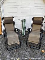 Two antigravity chairs and folded camp chair in bag