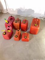 All seven gas cans grouped to show sizes, colors, caps, and spouts