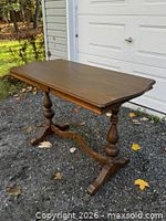 Table front angled view showing overall design and pedestal base