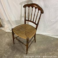front view of antique wood chair with woven rush seat