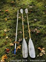 Two Werner oars and Sea-Dog grab pole on grass