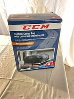 Front of sealed CCM rooftop cargo bag retail box