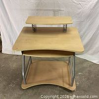 Front view of workstation desk showing monitor shelf, main surface, keyboard tray and lower shelf