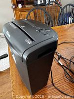 Top and side view showing Fellowes logo, model XC-9, control switch, power cord