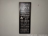 Full view of framed canvas quote wall art hanging on wall
